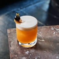 Et glas med en gul-orange drink